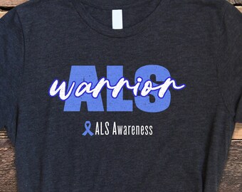 May include: A dark gray t-shirt with the text "ALS Warrior" in blue with a blue ribbon and the text "& ALS Awareness" underneath.