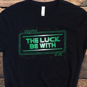 May include: Black t-shirt with a green graphic that says "May the luck be with ye" in a Star Wars-inspired font.