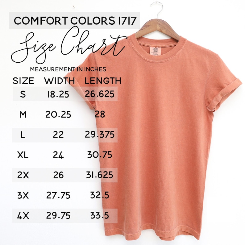 May include: A coral-colored short-sleeve t-shirt hanging on a wooden hanger, accompanied by a Comfort Colors 1717 size chart. The chart lists measurements in inches for sizes S through 4X, detailing specific width and length dimensions for each.