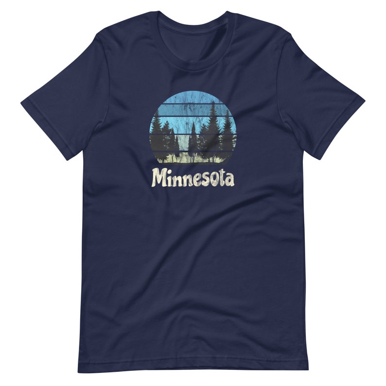 May include: A navy blue t-shirt with a retro-style graphic of a sunset with trees in front of it. The text "Minnesota" is printed below the graphic.