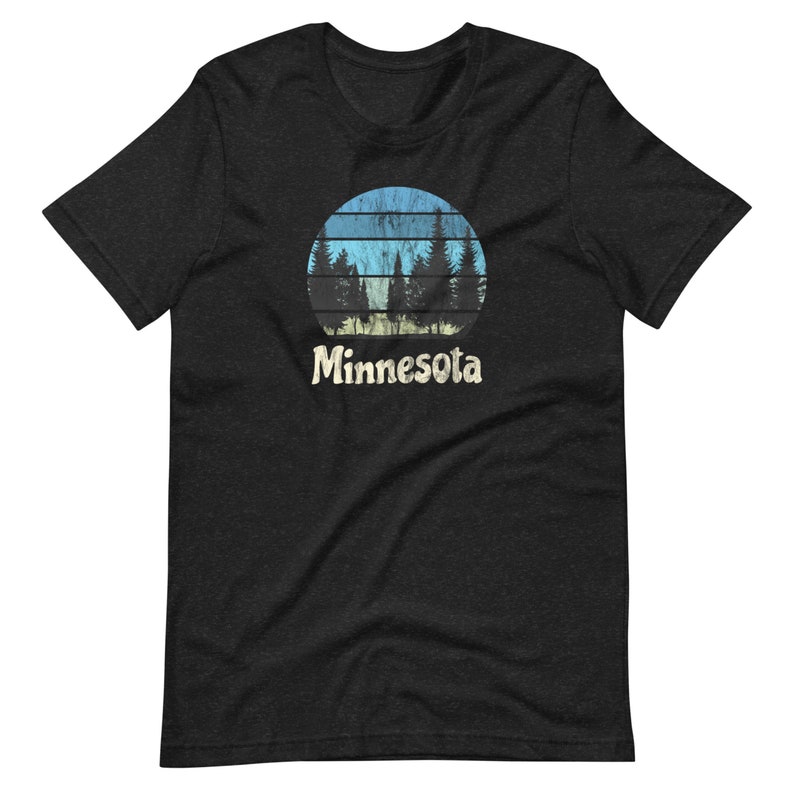 May include: Black t-shirt with a vintage-style graphic of a blue and yellow sunset with trees in front of it. The text "Minnesota" is below the graphic.