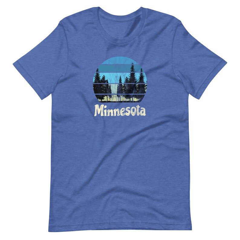 May include: A blue t-shirt with a retro-style graphic of a sunset behind a forest silhouette. The text "Minnesota" is printed below the graphic.