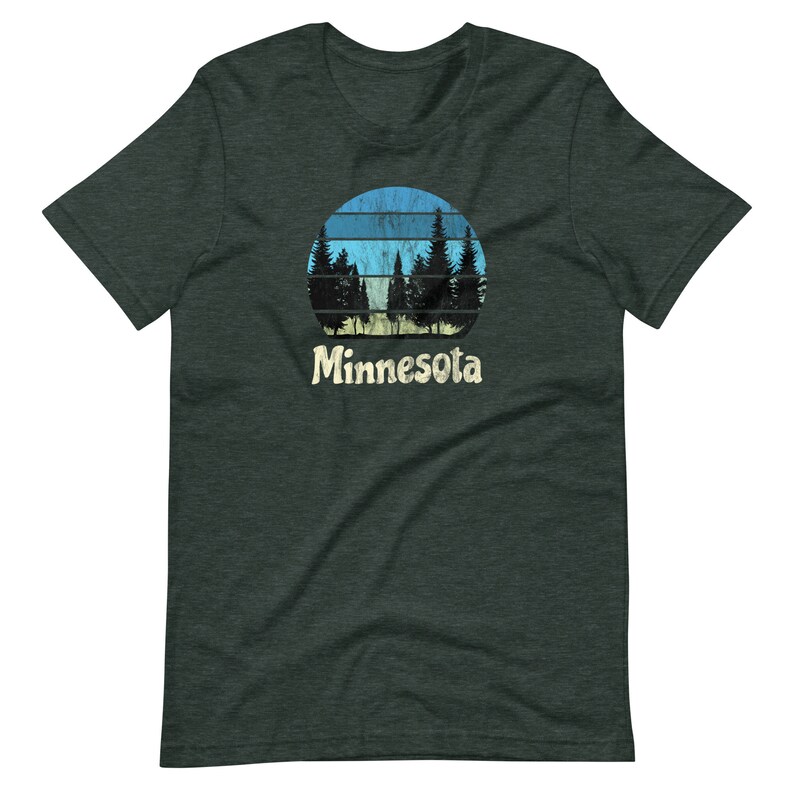 May include: A dark green t-shirt with a retro-style graphic of a blue and yellow sunset with trees in front of it. The text "Minnesota" is printed below the graphic.
