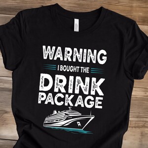 May include: A black short-sleeve t-shirt featuring white text that reads WARNING I BOUGHT THE DRINK PACKAGE with teal horizontal lines and a graphic illustration of a large cruise ship sailing on teal water at the bottom of the design.
