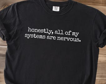 May include: Black t-shirt with the white text "honestly, all of my systems are nervous." The shirt has a crew neck and short sleeves. The shirt is made of a soft material.