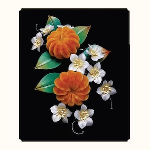 May include: An arrangement of artificial flowers against a black background. The arrangement features two large, orange, textured, spherical flowers, surrounded by smaller white flowers with gold centers and green leaves. The overall design is elegant and decorative.