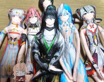 May include: A collection of anime-style character dolls with detailed facial features and colorful outfits. The dolls have various hair colors, including black, pink, and blue. The dolls are standing close together, creating a group of characters.