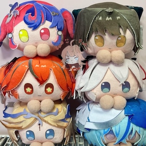 May include: A stack of plush dolls with large, expressive eyes and colorful hair. The dolls have round faces, with details like pom-pom noses and decorative accents. The color palette includes pink, blue, orange, green, and white.