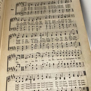 May include: A vintage sheet music book with the title "Sing Hosanna" by Fredric W. Root. The music is written in black ink on a cream-colored paper. The sheet music is for a song about the birth of Jesus Christ.
