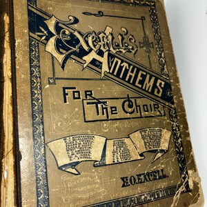 May include: A vintage book cover with a brown background and black text. The title is "Excel's Anthems for the Choir". The cover lists contributors and the price per dozen and by mail. The book is published by Clark & Adams, Lakeside Publishing Co.