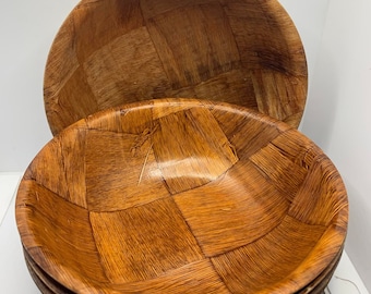 May include: Set of four brown woven wooden bowls. The bowls are stacked on top of each other.