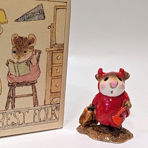 May include: A miniature mouse figurine in a red outfit, holding a shovel and a bag, beside a box. The box features illustrations of mice and the text "Wee Forest Folk". The illustrations show mice in different settings.