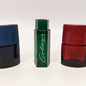 May include: Three small perfume bottles, one blue, one green, and one red. The green bottle has the text "Colors de Benetton" on it.