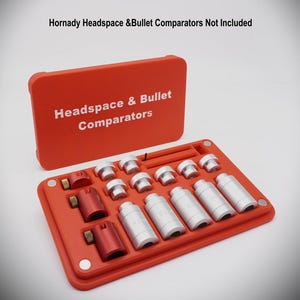 May include: An orange Headspace & Bullet Comparators kit with the text "Headspace & Bullet Comparators" on the lid. The kit contains silver and red metal tools, organized in a tray.