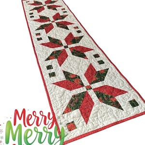 May include: A rectangular quilted table runner featuring a repeating star pattern in red and green fabric on a white background. The runner has a red border and intricate stitching throughout. The text Merry Merry Christmas is printed below.