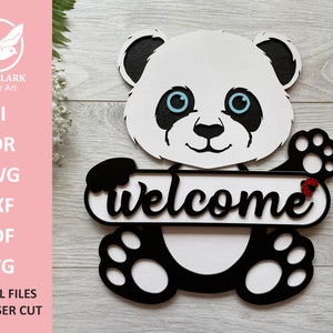 May include: A black and white panda bear holding a sign that says "welcome". The panda has blue eyes and a red ladybug on its paw.
