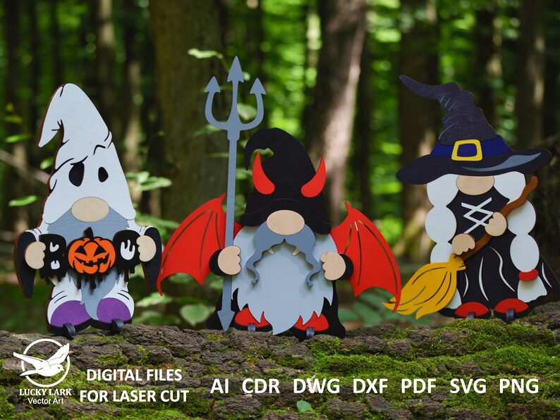 May include: Three Halloween gnomes, one dressed as a ghost holding a pumpkin and a sign that says "Boo", one dressed as a devil with red wings and a trident, and one dressed as a witch with a black hat and a broom.