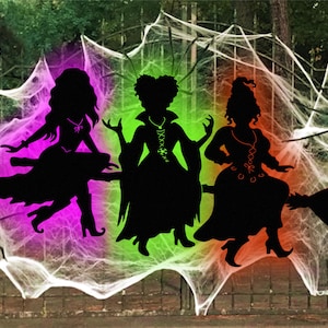 May include: Silhouette art of three witches on brooms against a backdrop of cobwebs, spiders, and a fence. The background features a gradient of colors, including purple, green, and orange. The Lucky Lark Vector Art logo is in the upper left corner.