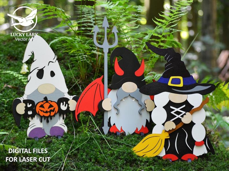 May include: Three Halloween gnomes, one dressed as a ghost holding a pumpkin and "BOO" sign, one dressed as a devil with red wings and a trident, and one dressed as a witch with a black hat and broom.