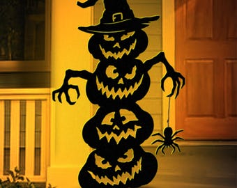 May include: Black Halloween decoration featuring three stacked jack-o'-lanterns with carved faces and a witch's hat. A spider hangs from the bottom pumpkin. The image includes text: "LUCKY LARK Vector Art" and "PDF File: US Letter / A4 Prints".
