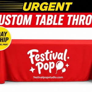 May include: A rectangular red table throw featuring a white graphic print on the front panel. The print displays the text Festival Pop in a stylised font, accompanied by two balloon icons, four-pointed star shapes, and the website festivalpopstudio.com.