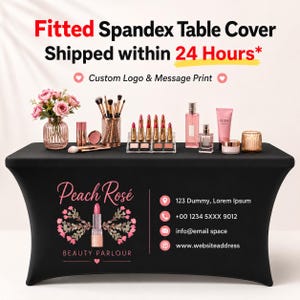 May include: A black fitted spandex table cover featuring a custom logo for Peach Rosé Beauty Parlour, including a lipstick graphic, floral accents, and contact information. The table is displayed with various makeup products and a flower vase.