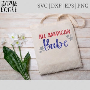 May include: A white tote bag with the text "ALL AMERICAN Babe" in red, blue, and gray with a distressed look. The text is surrounded by gray stars.