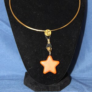 Gold choker with orange star
