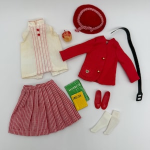 May include: A doll clothing set including a sleeveless white top with red vertical stripes, a red blazer with gold buttons, a red and white houndstooth pleated skirt, a red hat, red shoes, white socks, a black belt, an apple, and two books labeled ARITHMETIC and ENGLISH.