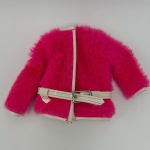 May include: A bright pink faux fur jacket featuring long sleeves and a white trim along the front opening and hem. The jacket includes a white belt with a silver-toned metal buckle that secures around the waist, providing a structured look.