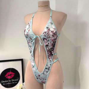 High leg open front bodysuit with thong style back.