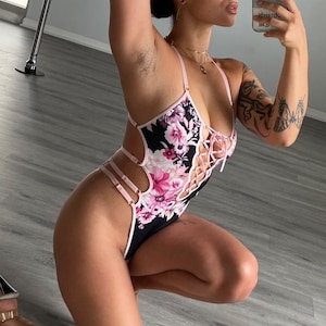 Black and pink high leg bodysuit. Thong style back. Wider gusset option available for additional coverage.