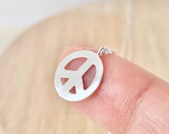 May include: Silver peace sign pendant necklace. The pendant is 12mm wide, 15mm high, and 0.2mm thick. The necklace is 45cm long, or about 18 inches.