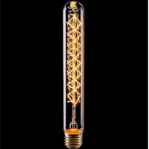 May include: A long, clear glass light bulb with a coiled filament inside. The filament is lit and glowing a warm yellow colour.