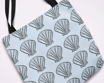May include: A light blue tote bag featuring a repeating pattern of black and white seashell illustrations. The bag has black handles and is made of a durable fabric, suitable for carrying groceries or personal items.