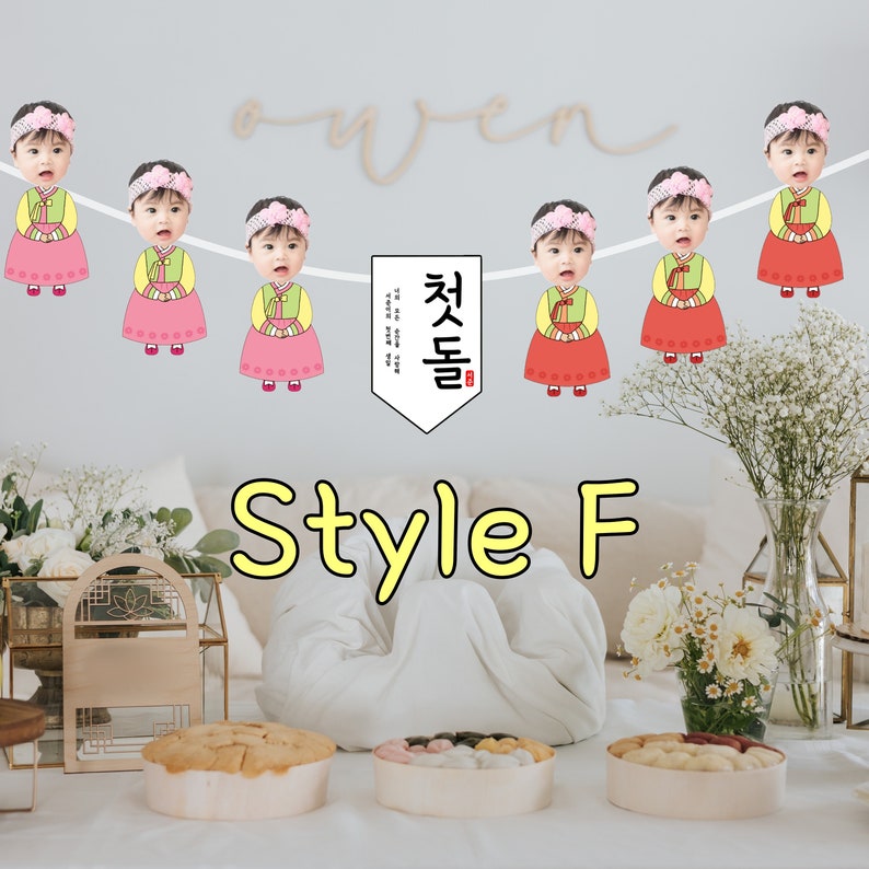 May include: A white banner with a string of colorful paper dolls with faces. The dolls are wearing traditional Korean clothing. The banner says "Style F" and "Che Se Dool" in Korean.