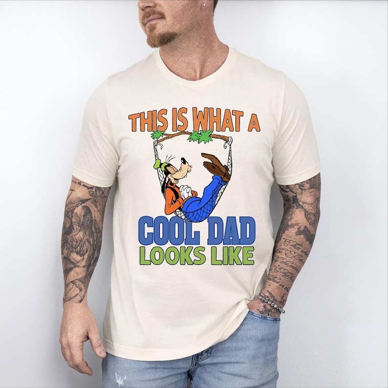 a man wearing a t - shirt that says, this is what a cool dad