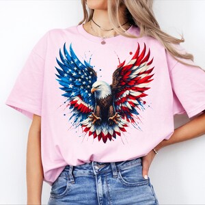 A woman wearing a pink t-shirt with an American eagle design and a patriotic flag pattern.