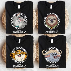 four black t-shirts with cartoon animal faces and the text "Disney Zootopia 2" printed on them.
