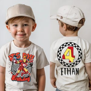 A young boy wearing a white t-shirt with a graphic design and text, including a character and the number 4.