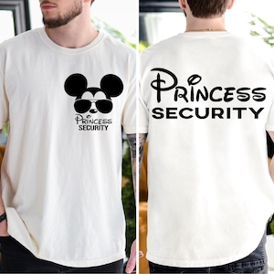 May include: White t-shirt with a black Mickey Mouse graphic wearing sunglasses and the text "Princess Security" on the front. The back of the shirt has the text "Princess Security" in a stylized font.