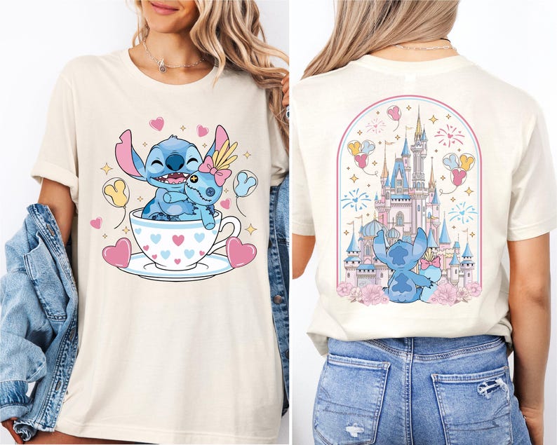 A woman wearing a white t-shirt with a graphic design featuring a blue character, likely Stitch, sitting in a teacup with hearts and a castle in the background.