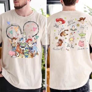 The image is a collage of two photos. The left photo shows a person wearing a white t-shirt with a cartoon character design featuring various characters from the Toy Story franchise. The right photo shows the back of the same person's t-shirt, featuring a variety of cartoon characters and a signature.