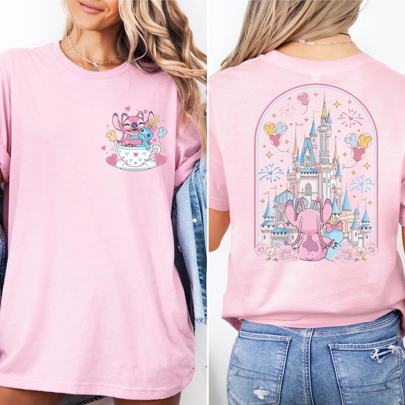 A woman wearing a pink t-shirt with a castle and a cup of tea graphic on the front and a castle and a cup of tea graphic on the back.