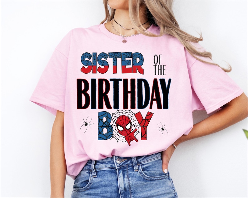 A woman wearing a pink t-shirt with the text "SISTER OF THE BIRTHDAY" printed on it.