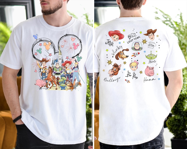 A white t-shirt with a collage of various characters from the Toy Story franchise, including Buzz Lightyear, Woody, and other beloved characters.
