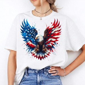 A woman wearing a white t-shirt with an American eagle design and red, white, and blue colors.