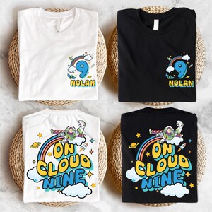 four t-shirts, each with a unique design and color, arranged on a woven basket. The t-shirts feature various cartoon characters and text, including the words "Nolan" and "On Cloud Nine".