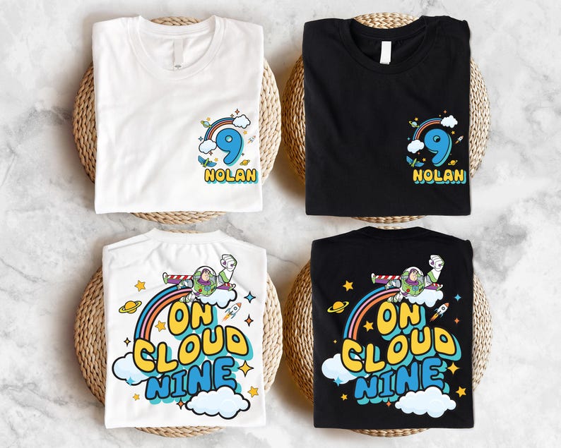 four t-shirts, each with a unique design and color, arranged on a woven basket. The t-shirts feature various cartoon characters and text, including the words "Nolan" and "On Cloud Nine".