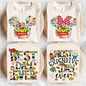 May include: Four beige t-shirts with Toy Story characters. The first two shirts feature a Mickey Mouse head silhouette made of Toy Story characters with the text "Toy Story". The bottom two shirts feature the text "Best Day Ever" and "Most Expensive Day Ever" with Toy Story characters incorporated into the letters.